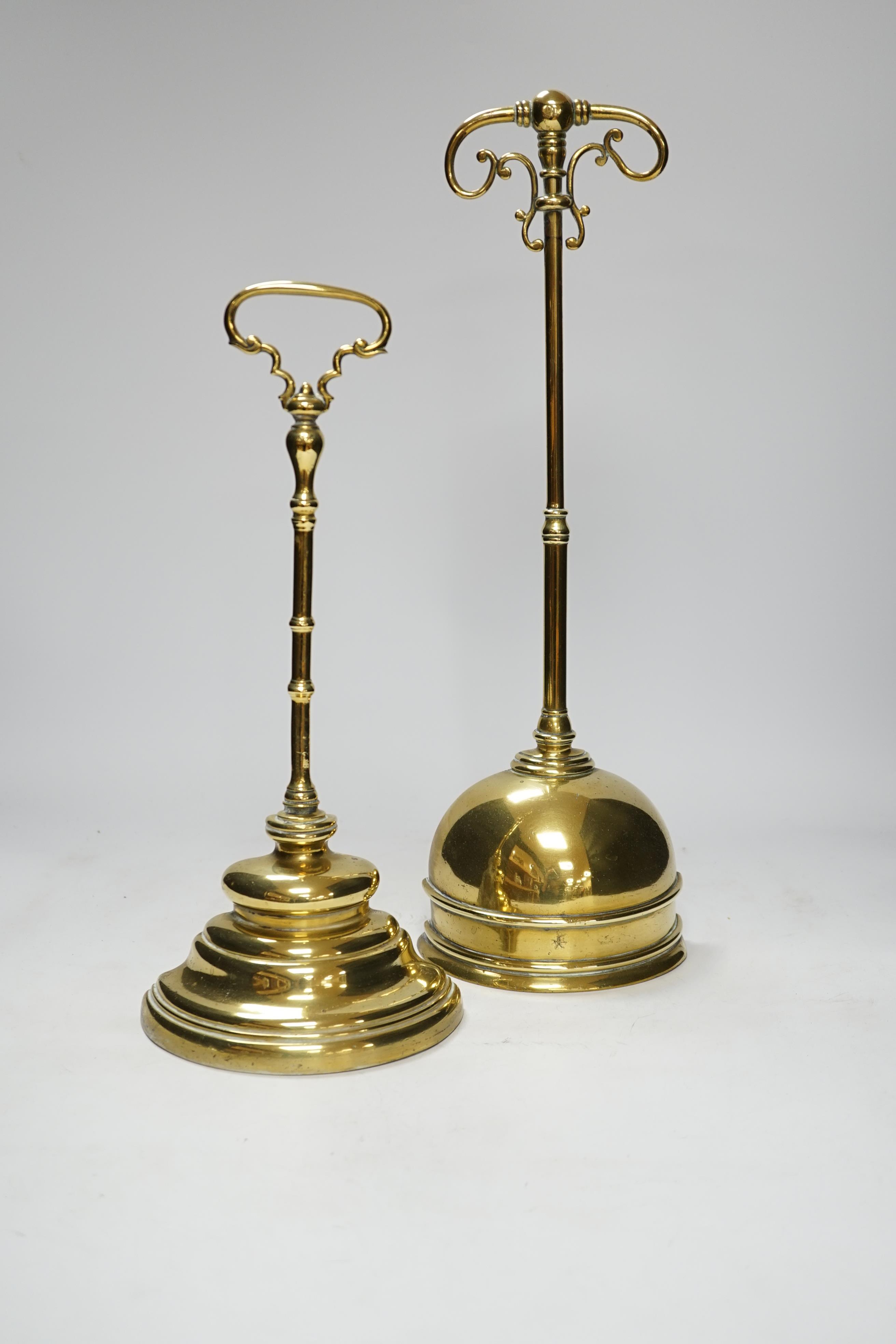 Two early 19th century cast brass door stops, with moulded stepped plinths, largest 45cm high